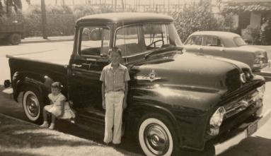 Two children in front of their father's Ford F-100 truck